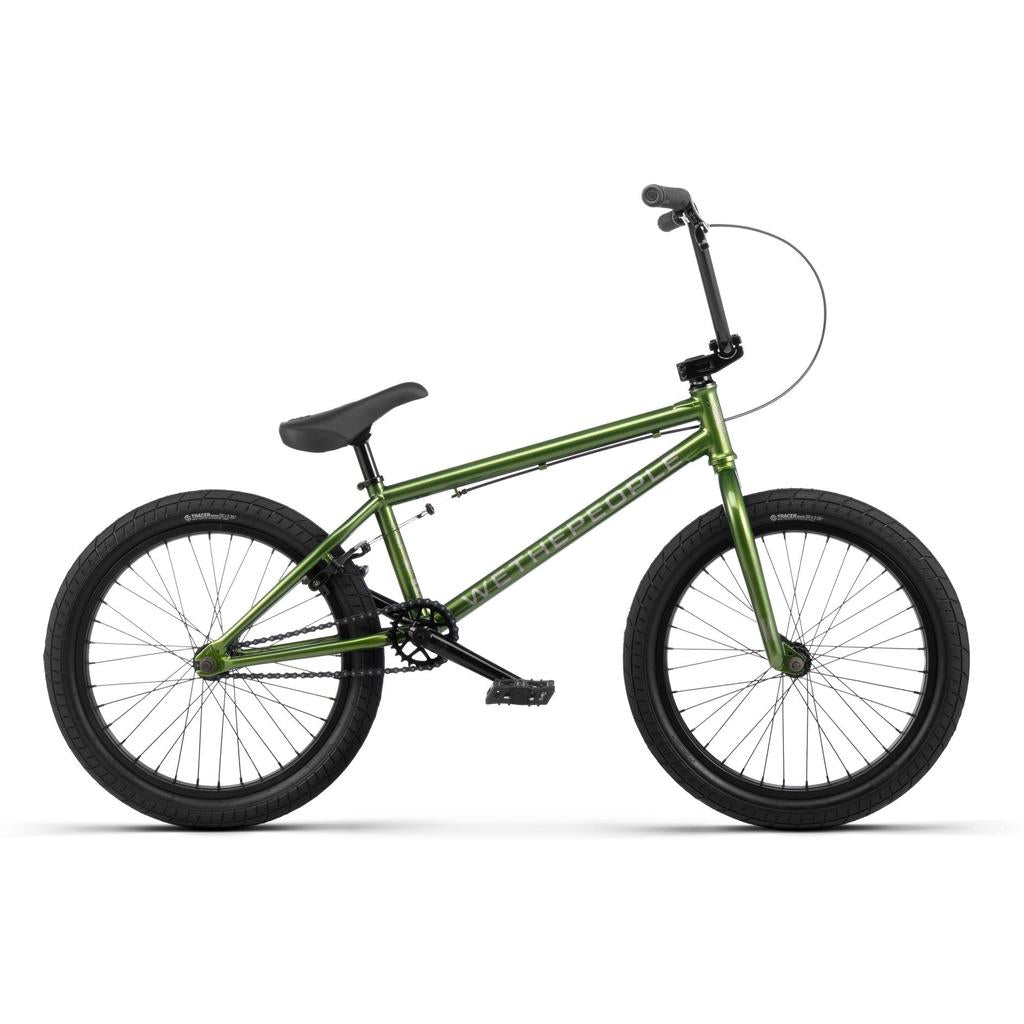 The Wethepeople CRS 20 Inch Bike is displayed in green with black tires, a black seat, and straight handlebars, shown in a side profile against a white background.