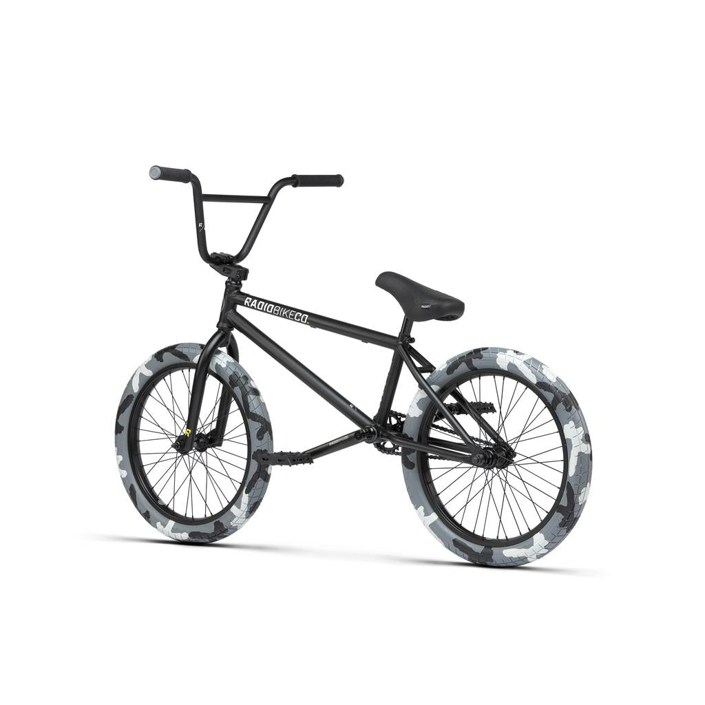 The Radio Darko 20 Inch Bike, shown on a white background, features a black chromoly frame with “RADIOBIKES.COM” branding and thick Salt Burn Tyres in a gray and white camouflage pattern.