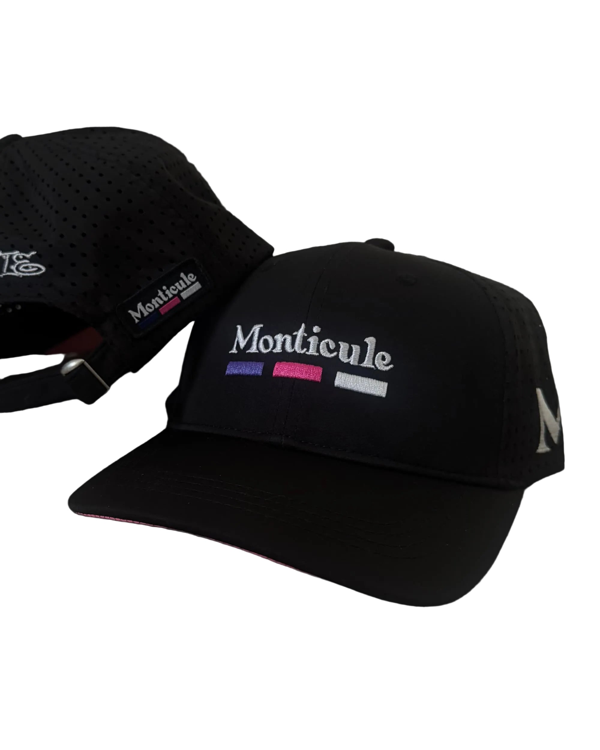 Two black Monticule Vapor Strap Back Hats, featuring "Monticule" embroidered on the front with colored stripes and a breathable mesh back; one hat is shown from the front, the other from the back.