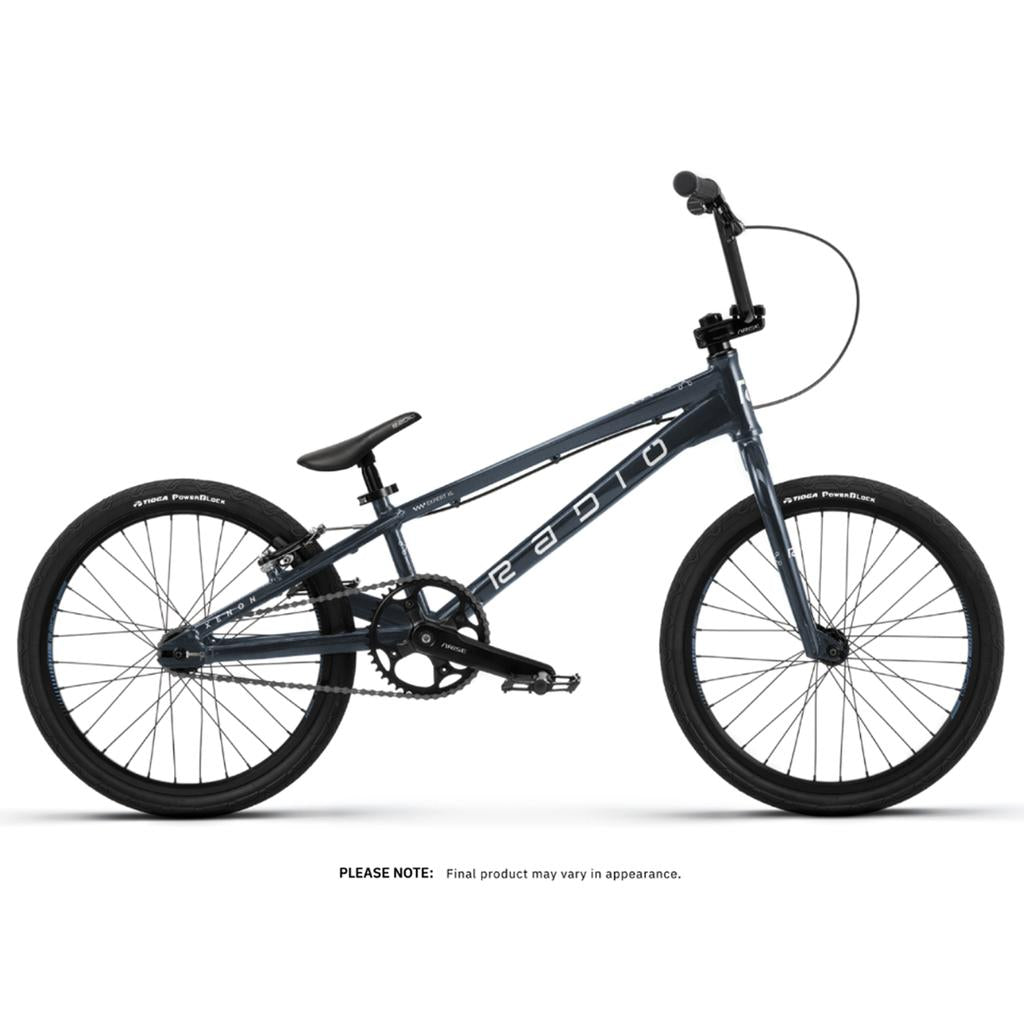 The Radio Xenon Expert XL Disc 20 Inch Bike is a dark blue BMX with a lightweight alloy frame, black tires, small padded seat, straight handlebars, and white "RADIO" branding on the side.