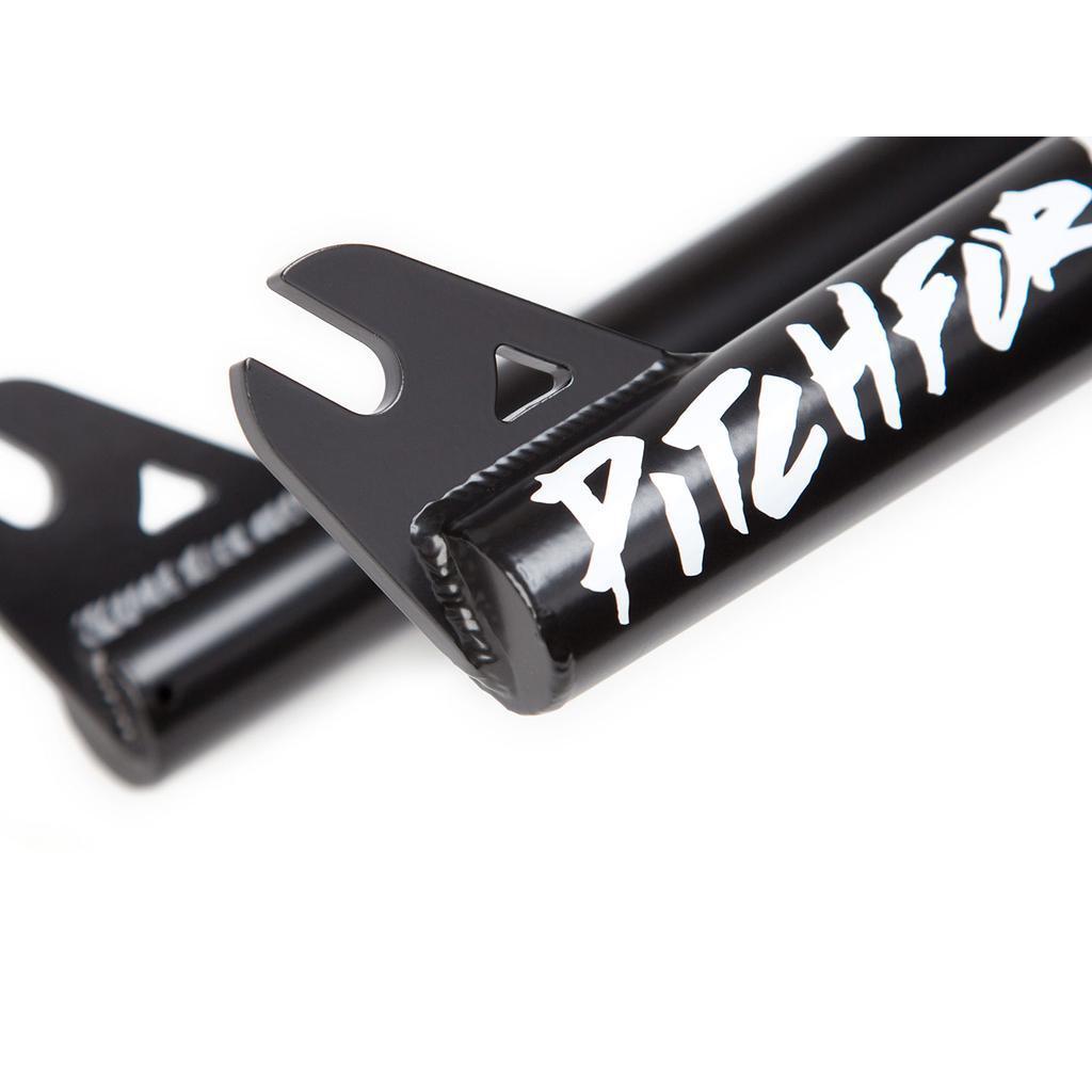 Close-up of two black metal BMX fork dropouts, one labeled "PITCHFORK" in bold white—highlighting the sturdy S&M Pitchfork XLT 22inch Forks design.