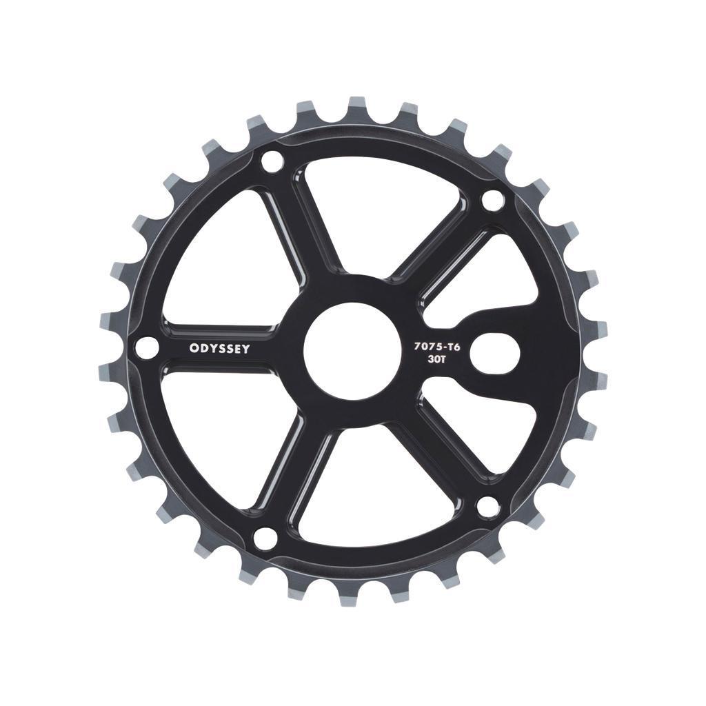 The Odyssey Utility Pro Sprocket, a black metal BMX sprocket featuring 30 teeth and marked with “ODYSSEY 7075-T6 30T,” is displayed against a white background. Engineered for durability, this sprocket can be paired with an optional plastic bash guard for enhanced protection.