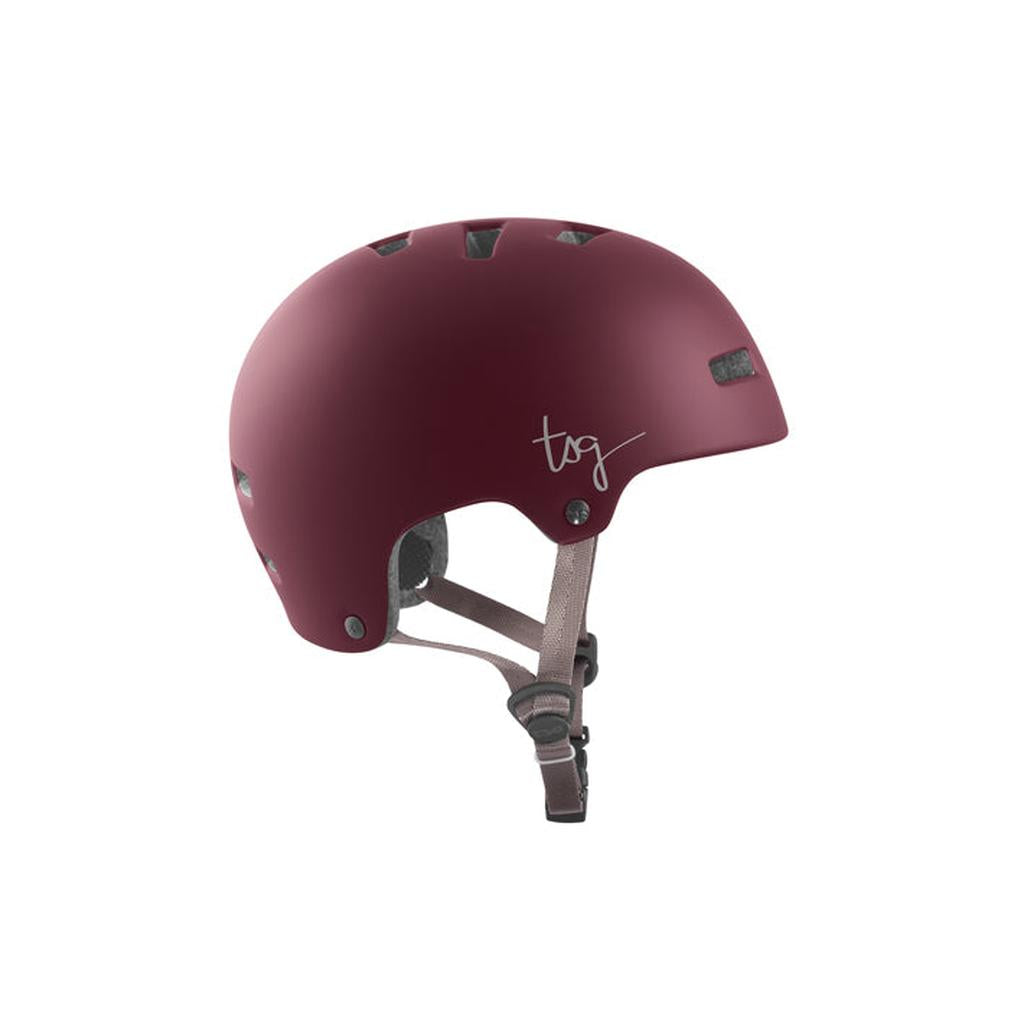The TSG Nipper Maxi Helmet in Satin Cabernet is a matte burgundy youth helmet with ventilation holes, brown adjustable chin straps, and a white "tsg" logo—lightweight and perfect for young skaters seeking comfort and style.