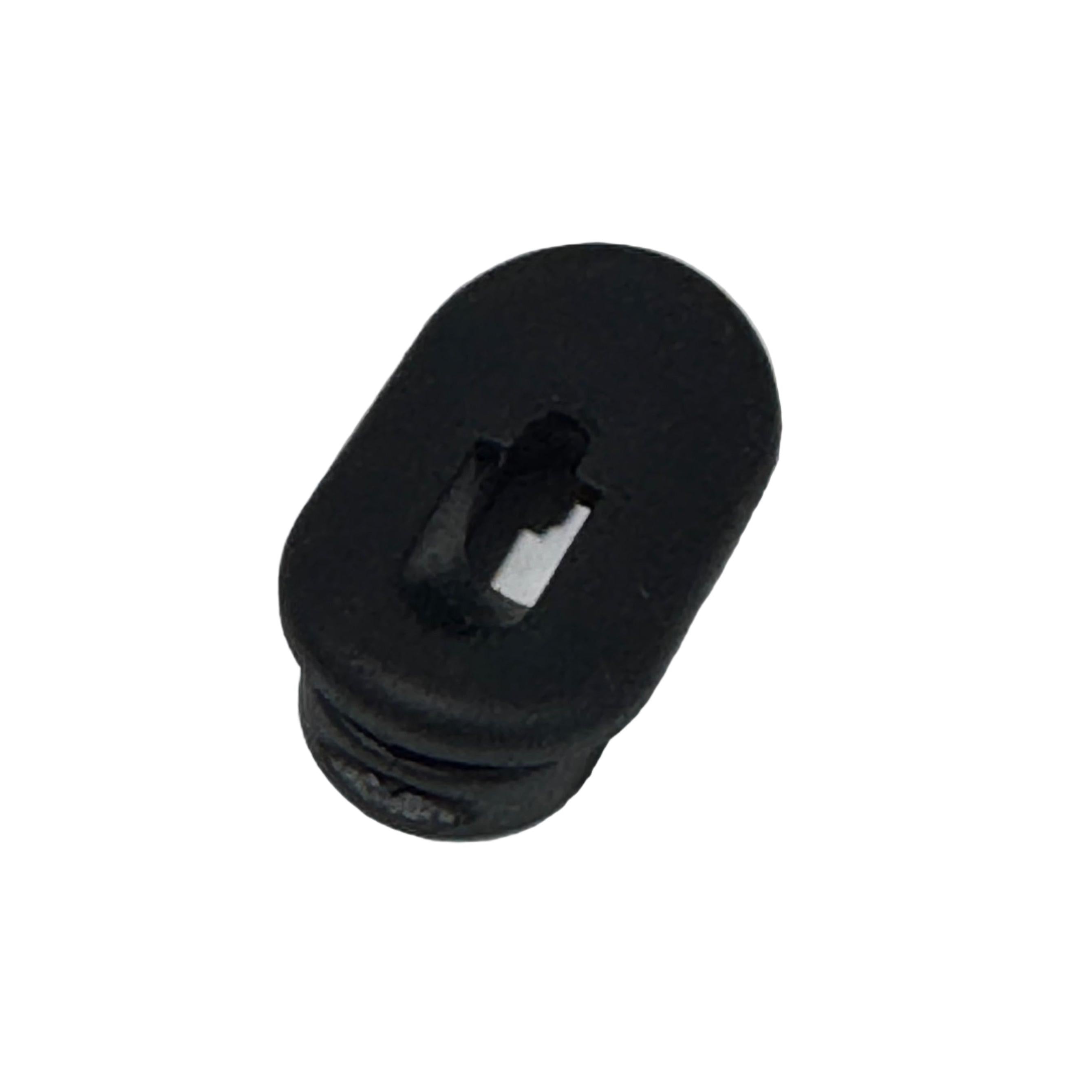 The Grommet For Internal Brake Hose Routing is a black plastic oval plug with a central slot, perfect for organizing brake hoses or internal routing; shown isolated on a white background.