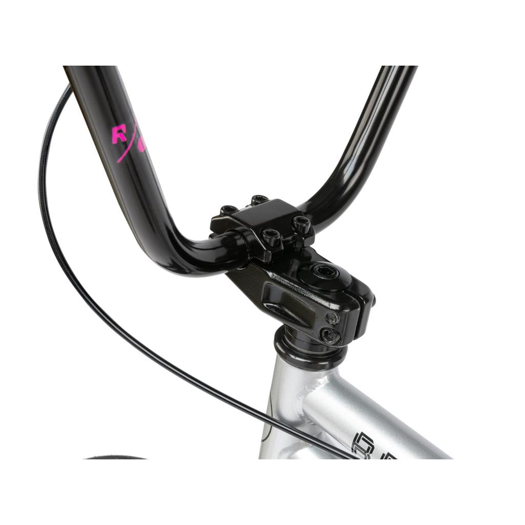 Close-up of a BMX handlebar stem and headset with black handlebars on a silver Radio Revo Pro 20 Inch Bike, showing visible brake cables.