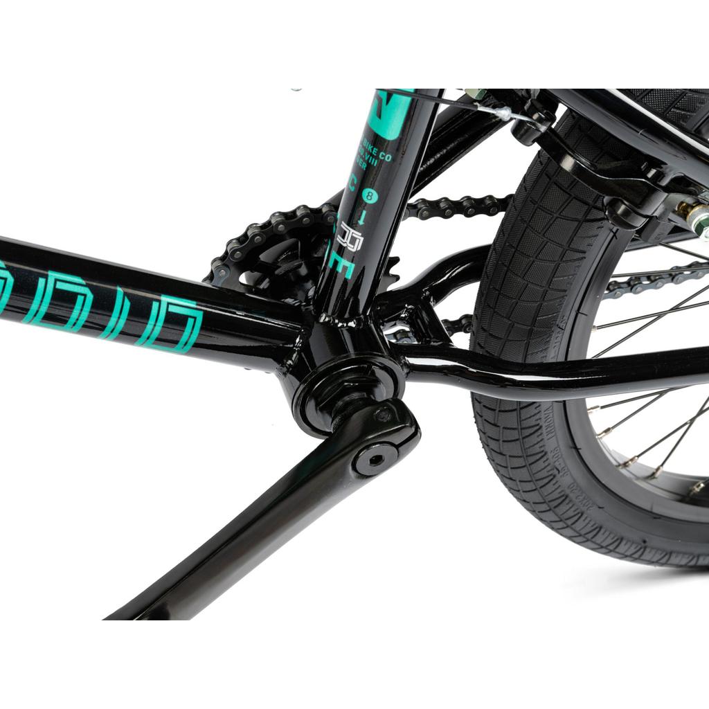 Close-up view of the Radio Revo Pro FS 20 Inch Bike's black crankset, chain, rear tire, and frame—showcasing connection details and tire tread pattern for a perfect 20-inch setup.
