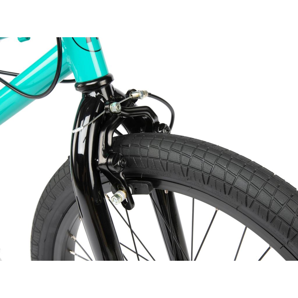 Close-up of a Radio Revo Pro FS 20 Inch Bike’s front wheel and fork, featuring the tire, black rim, spokes, side-pull caliper brake, and turquoise frame with a 20-inch top tube.