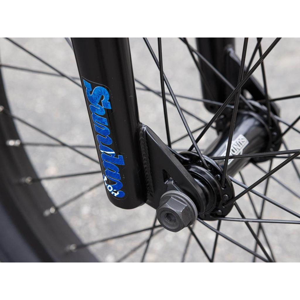 Close-up of the Sunday Forecaster Maca Grasset 20 Inch Bike's wheel hub, spokes, and fork with "Sunday" logo—ideal for riders building a park BMX or planning a gyro setup.