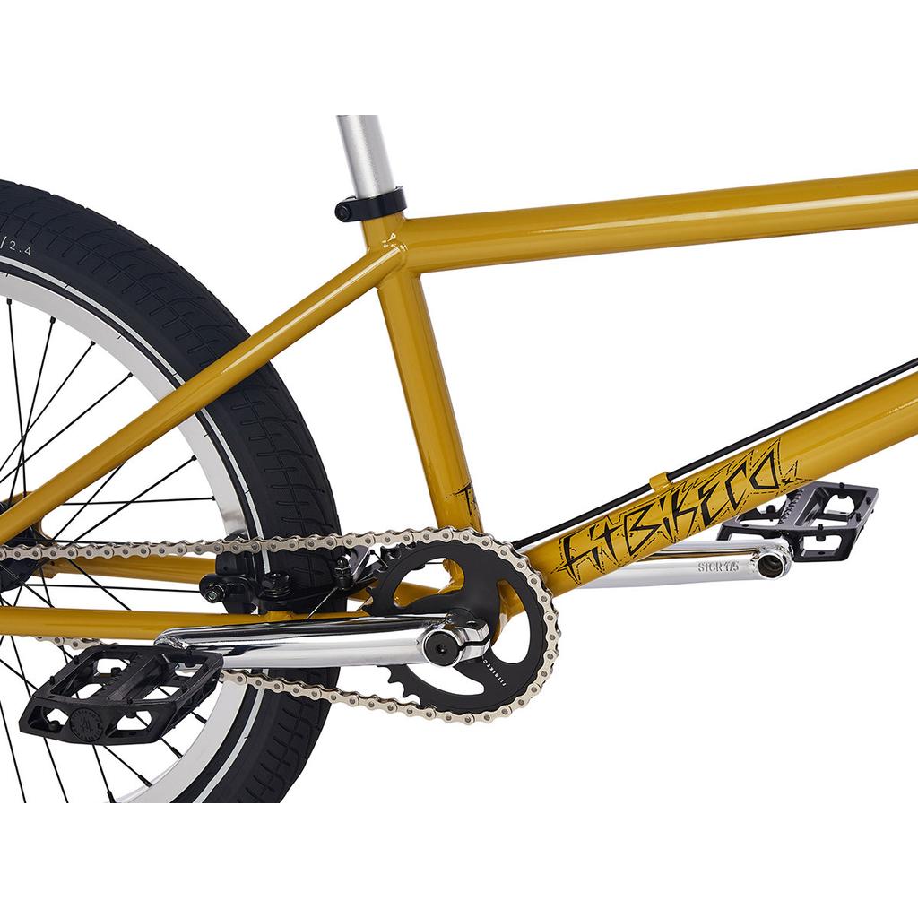 Close-up of a yellow 2023 Fit TRL Bike frame showing the chain, crankset, pedals, rear wheel, and seat post detail with "SWEETTOOTH" branding—ideal for riders who love trail geometry BMX bikes.