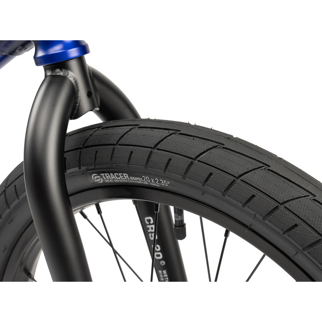 Close-up of the Wethepeople CRS FC 20 Inch Bike's front wheel and tire, featuring textured tread and sidewall markings that read "Tracer 20 x 2.35".