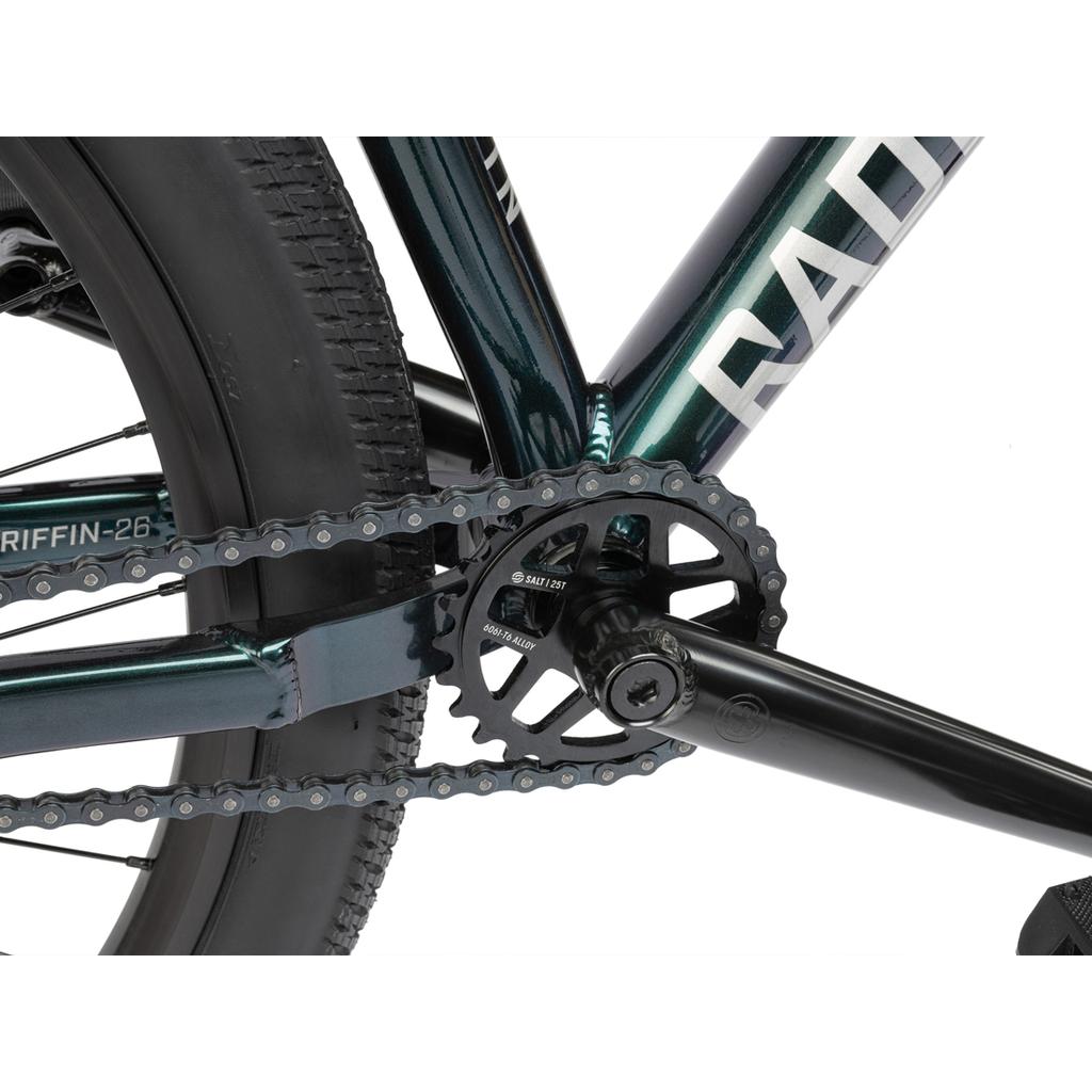 Close-up of the Radio Griffin 26 Inch Bike drivetrain, featuring the chain, chainring, crank arm, and rear wheel fitted with Maxxis DTH tyres, all set against a white background.