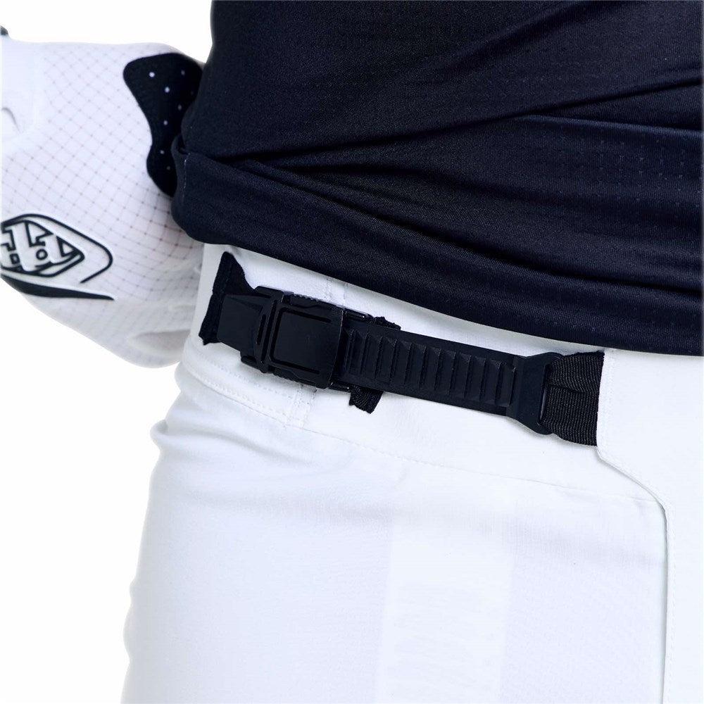 A person wearing TLD 26.1 Sprint Ultra Pant / Mono White with a lightweight design, a black belt with a plastic buckle, a black shirt, and a white sports glove on their left hand.