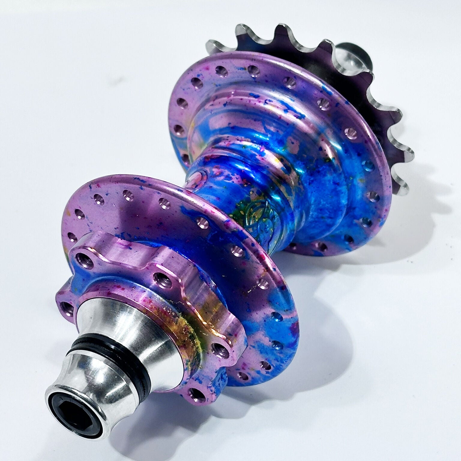 The Profile Mini Front & Rear Hub Set (LE-Galaxy Rust) / Disc Brake features an iridescent purple and blue finish with a silver cog and bolt, displayed on a plain white background—a striking limited edition hubset.