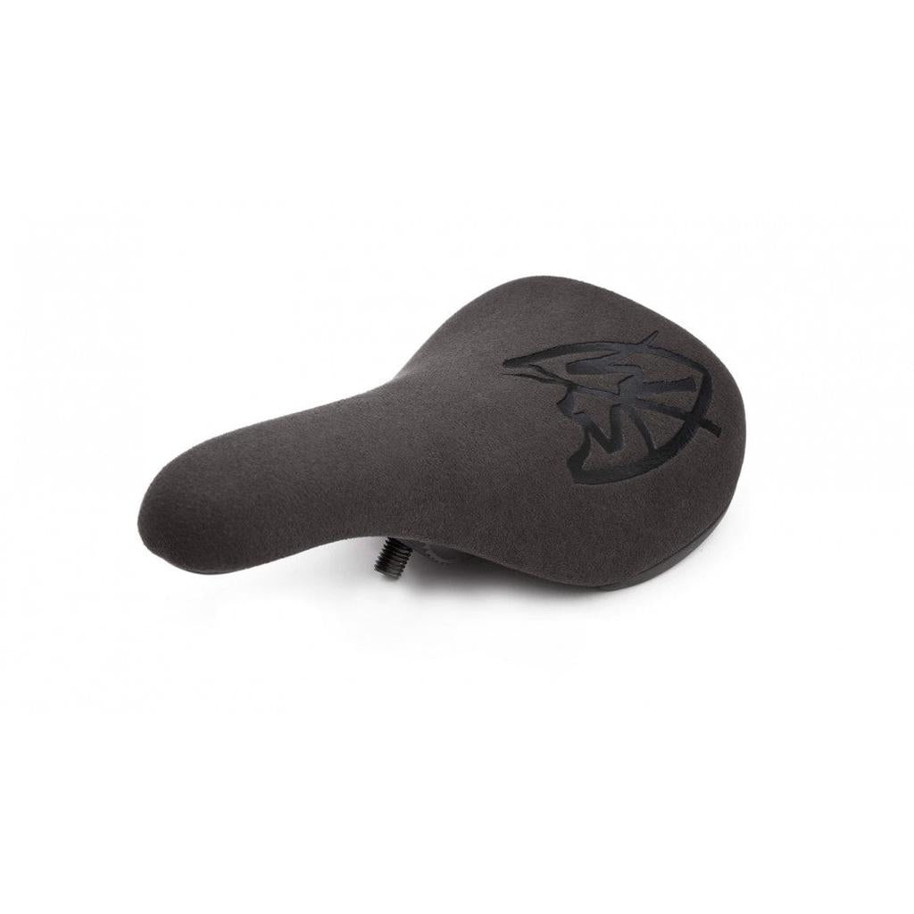 The S&M Stealth Slim Pivotal Seat is a black ergonomic bike seat with a textured surface and a stylized leaf design on top, shown from an angle.