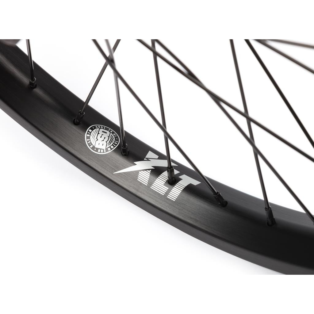 Close-up of the BSD XLT x Revolution V1.5 Rear Wheel, showing its black spokes, XLT branding, and BSD Revolution v1.5 hub against a white background.