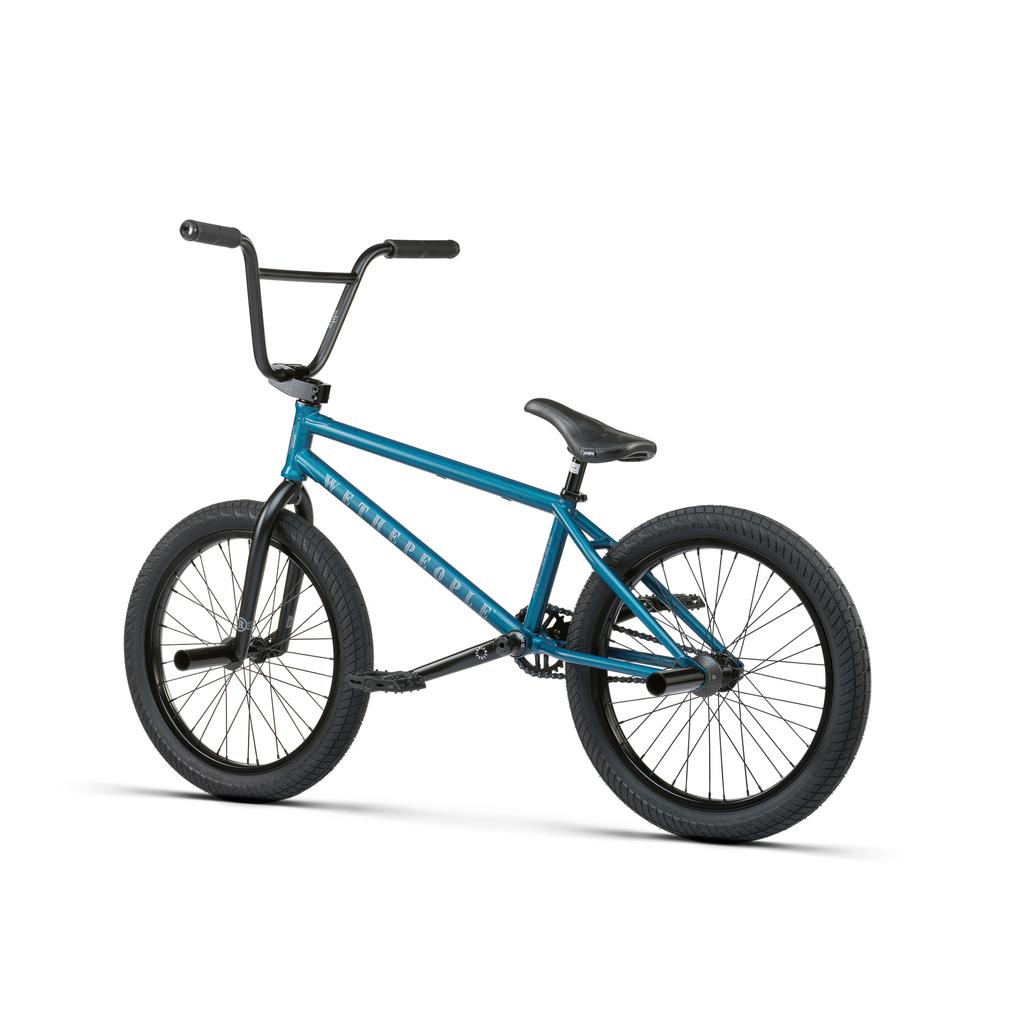 A blue Wethepeople Revolver 20 Inch Bike with black handlebars, seat, and tires is displayed against a white background. Ride confidently with its included lifetime guarantee.