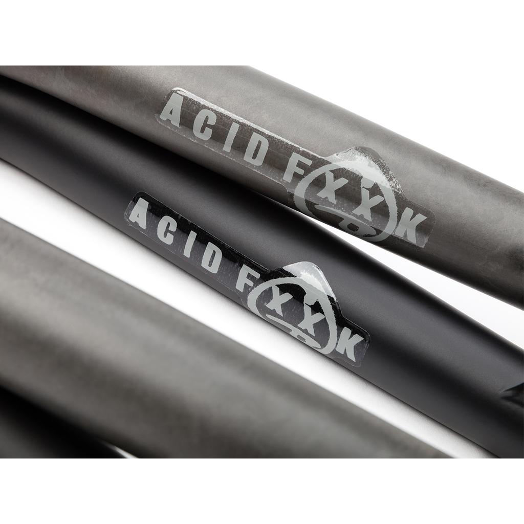 Close-up of three BSD Acid V2 Forks, made from 4130 chromoly and featuring "ACID FXXK" with a triangle symbol, arranged diagonally on a white background—ideal for BMX fork fans.