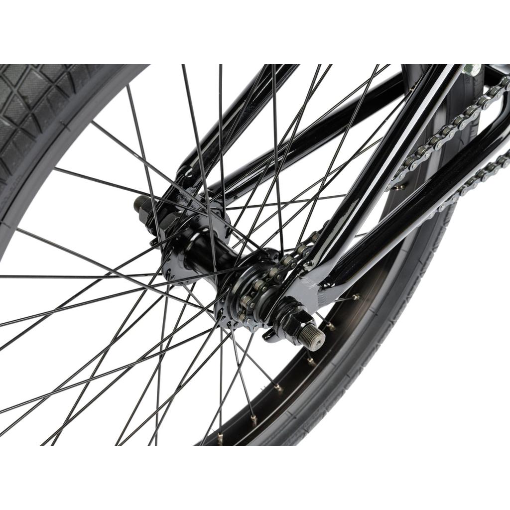 Close-up of the Radio Revo Pro FS 20 Inch Bike’s rear wheel, highlighting the tire, spokes, hub, axle, frame, and chain with a focus on its 20-inch top tube.