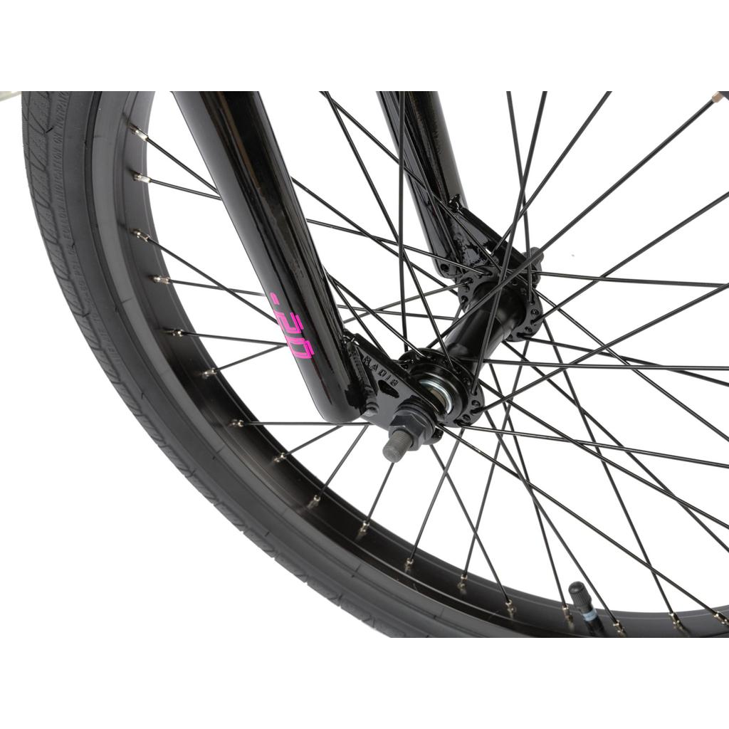 Close-up of the black BMX wheel, spokes, tire, and front fork with a pink "UCE" label—featuring the hub and axle on the Radio Revo Pro 20 Inch Bike.
