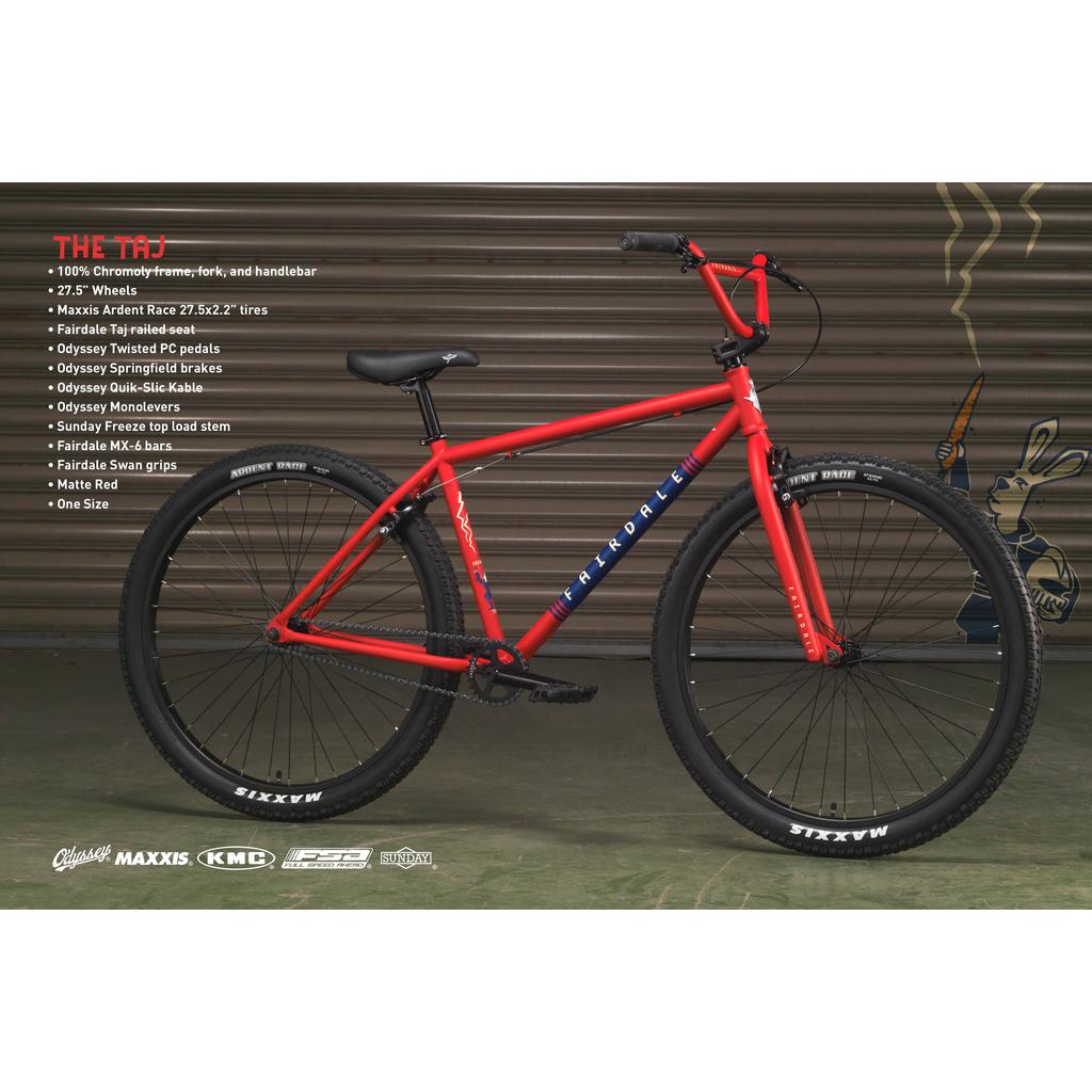 A Fairdale Taj 27.5 Inch Bike (2023), a stylish BMX commuter in red, is shown in front of a metal shutter door, with its specifications and brand logos displayed beside the bike.