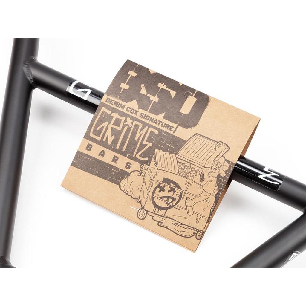 A cardboard tag labeled "BSD Grime 4 Piece Bars" with graffiti-style artwork is attached to black BMX handlebars.