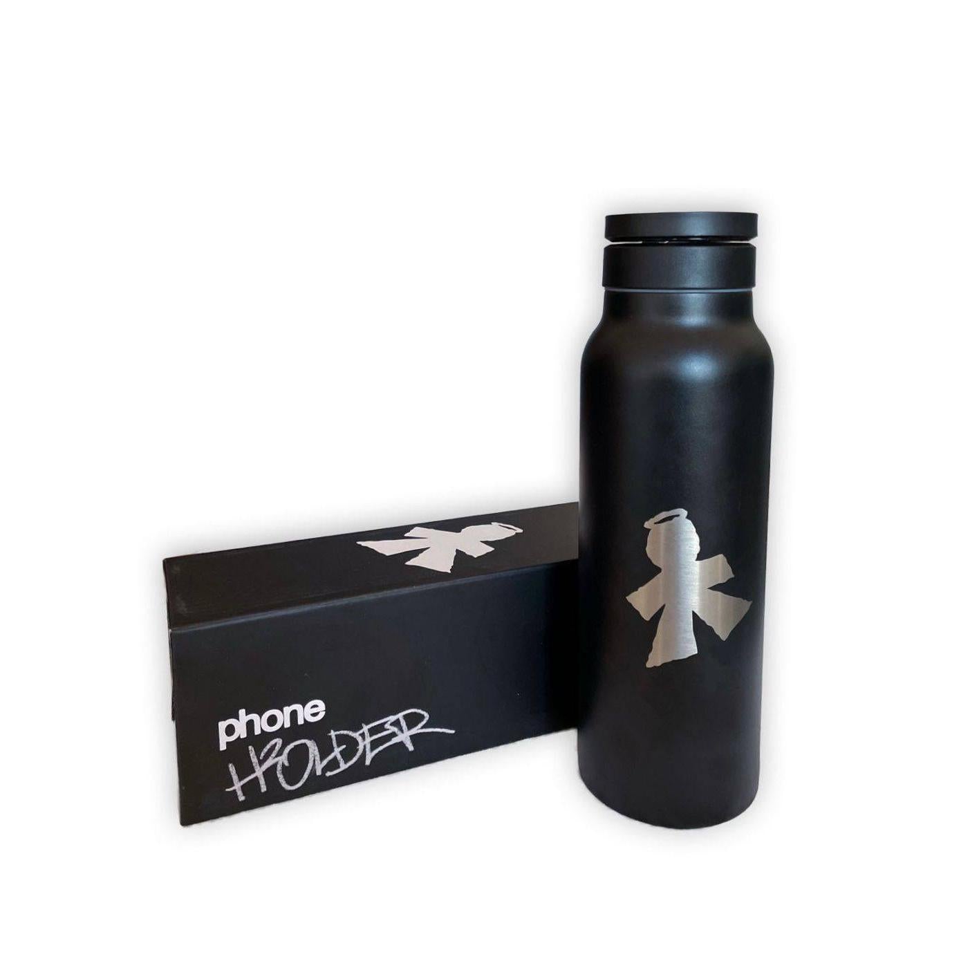 The V1da Phone Holder Drink Bottle, a black BPA-free bottle with a silver graphic, stands beside a sleek black box labeled "V1da Phone Holder" in white and silver text.