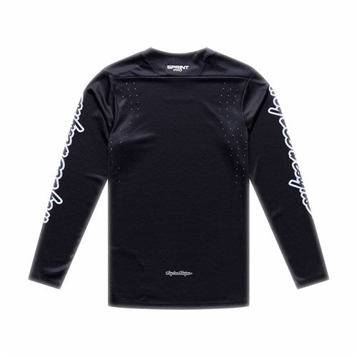 The TLD 26.1 Sprint Pro Jersey / Mono Black is a black long-sleeve jersey with white graphic text on the sleeves and upper back perforations for moisture wicking, shown on a flat white background.