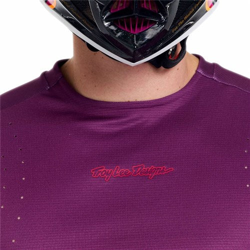 Person wearing a purple TLD 26.1 Sprint Pro Jersey / Mono Sangria and a full-face helmet, shown from shoulders to chin.