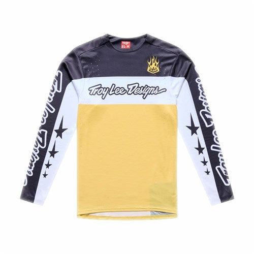 The TLD 26.1 Sprint Pro Jersey / Yo Moto Butter is a long-sleeve, race-fit jersey featuring "Troy Lee Designs" text, a black upper section, white stripe, yellow lower section, flame chest graphic, and moisture-wicking comfort.