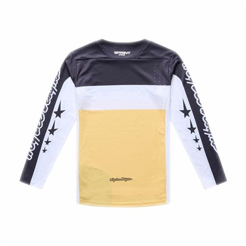 The TLD 26.1 Sprint Pro Jersey (Youth) / Yo Moto Butter features black, white, and yellow color blocks with star and script sleeve graphics plus small printed text for an authentic race fit cycling jersey style.