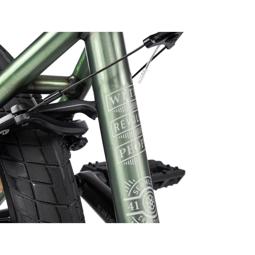 Close-up of a green BMX frame highlights the tire, brake, and detailed decals—showcasing premium parts inspired by the Wethepeople Revolver 20 Inch Bike.