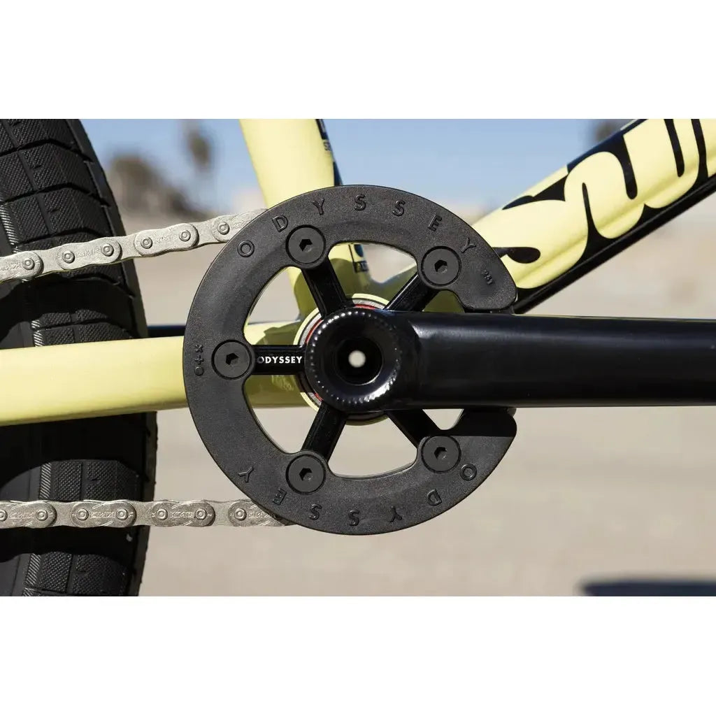 Close-up of the Sunday Soundwave Special Bike (2025) crankset with an Odyssey sprocket and guard, featuring Odyssey parts with 41-Thermal Lifetime Warranty—showing the chain, pedal arm, and part of the frame.