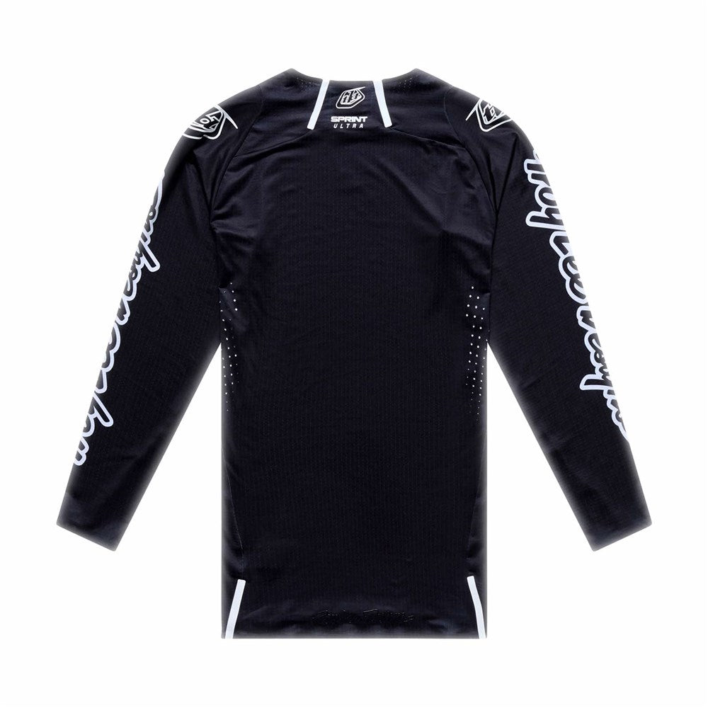The TLD 26.1 Sprint Ultra Jersey / Mono Black is shown laid flat, back view, featuring white logos and sleeve text. Made by Troy Lee Designs from Ultra Knit fabric for premium comfort.