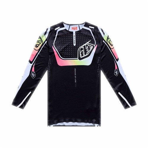 The TLD 26.1 Sprint Ultra Jersey / Proton Black by Troy Lee Designs is a long-sleeve jersey with colorful accents, geometric patterns, chest logo, and ultra knit fabric, shown on a plain white background.