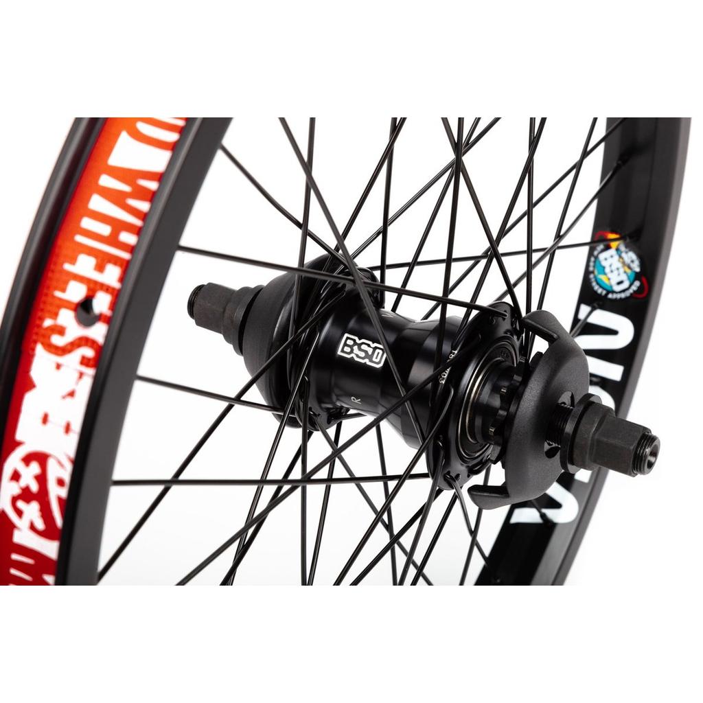 Close-up of a BSD Mind (NASA/West Coaster) Rear Wheel in black, showing spokes and bold red and white graphics on the BMX rim.