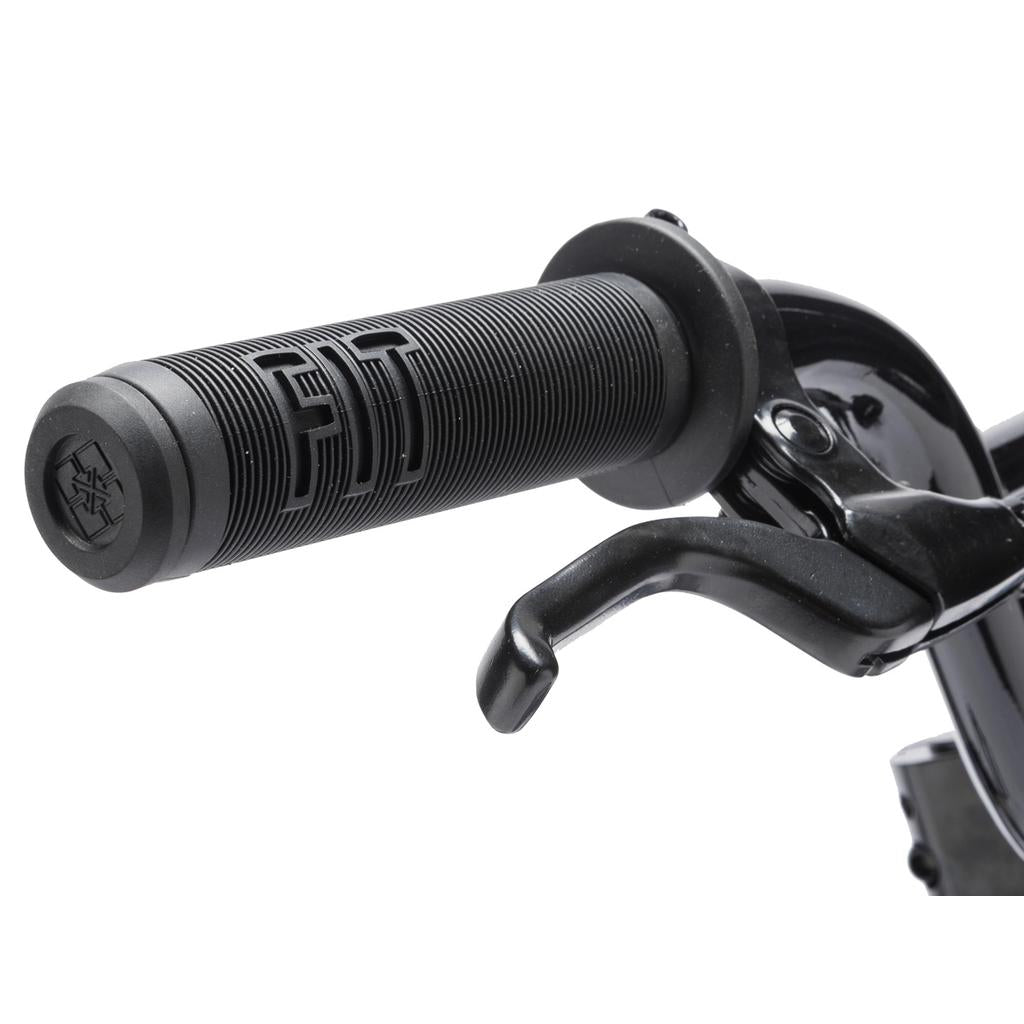 Close-up of a black handlebar with a textured rubber grip labeled "FIT" and a brake lever, designed for the Fit Misfit 12 Inch Bike—ideal as a first pedal bike for kids.
