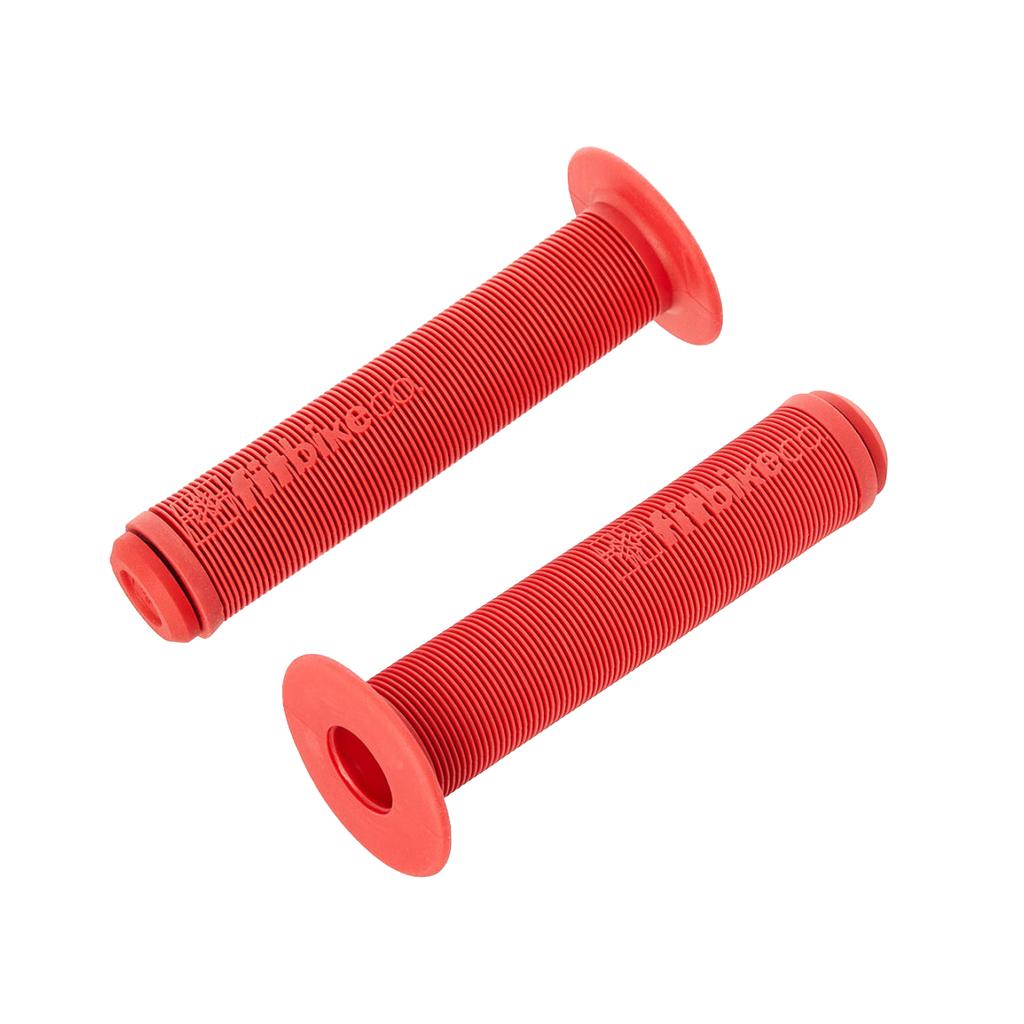 The Fit Bike Co OG Grips are red rubber BMX grips with flanged ends and a mushroom finned surface for a secure, comfortable hold. The ribbed texture provides optimal control—perfect as a replacement grip. Shown on a white background.