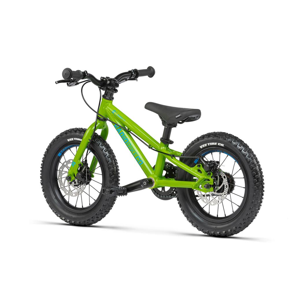 A Radio Zuma 14 Inch Bike for kids is shown on a white background, featuring thick tires, hand brakes, a black seat, and a green frame.