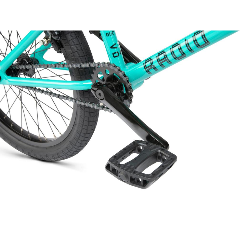 Close-up of the Radio Revo Pro FS 20 Inch Bike's rear wheel, black crank arm, pedal, and chain on a white background, highlighting its 20-inch top tube.