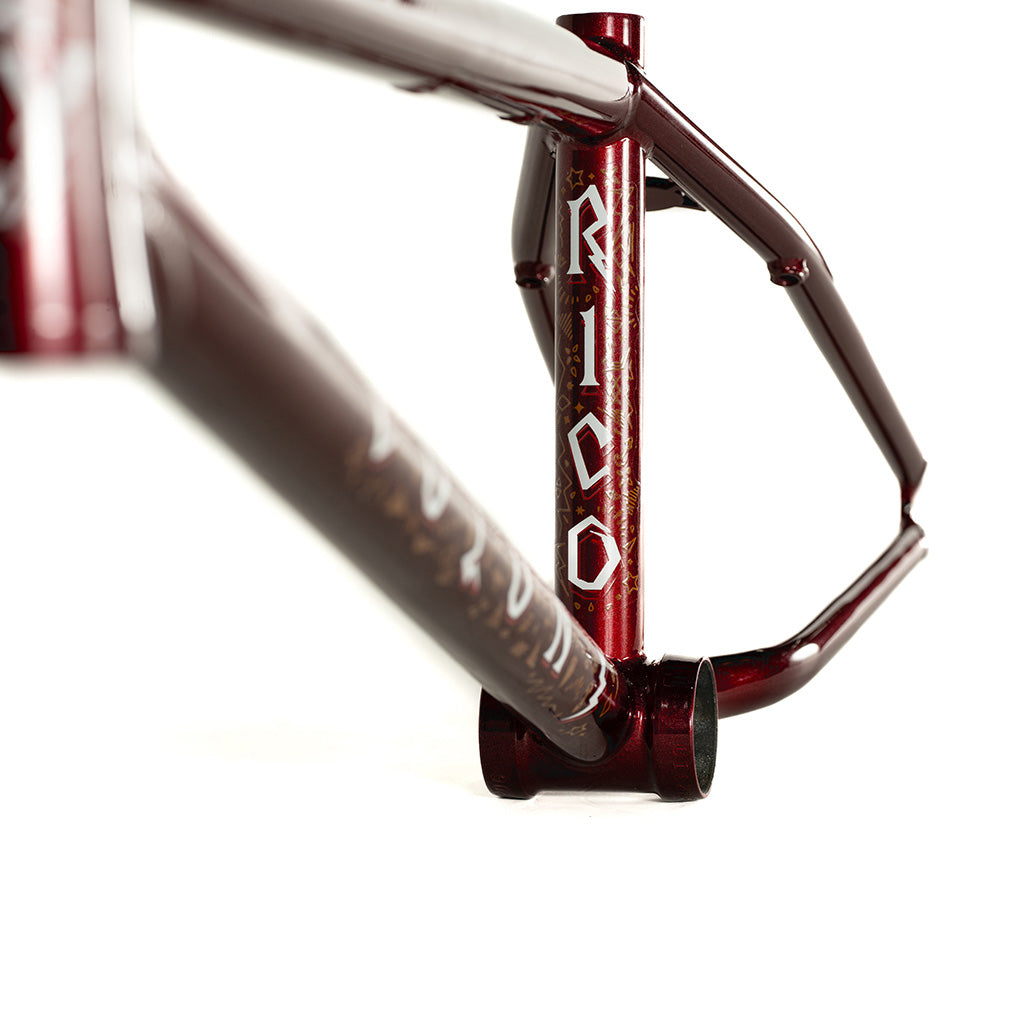 The Colony Rico 'Lite' Frame, designed by the technical wizard Paterico Fallico, showcases a sleek burgundy color with bold black lettering.