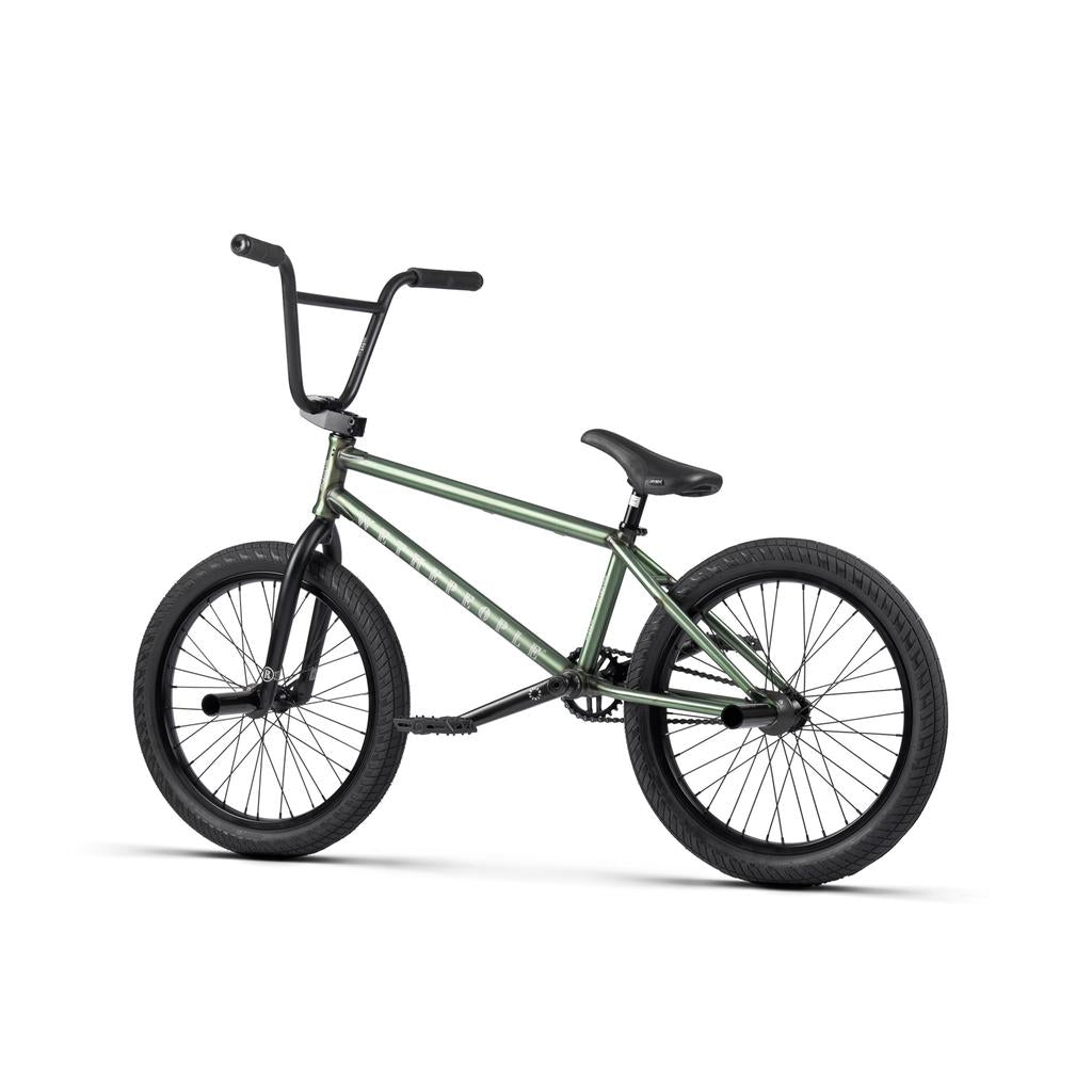 The Wethepeople Revolver 20 Inch Bike is shown in green with black handlebars, seat, and tires from the side against a white background—made with quality aftermarket parts and comes with a lifetime guarantee.