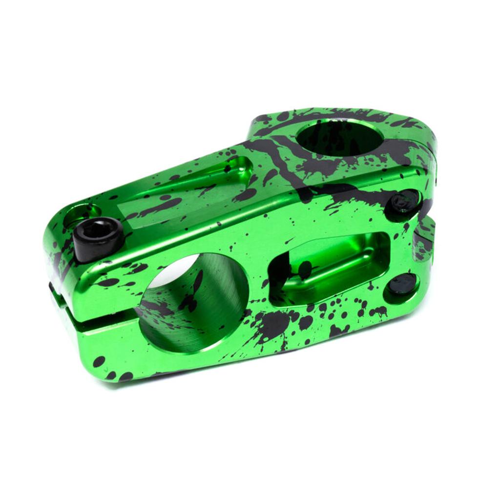 The Eclat Burns Stem features a green and black splatter pattern, is CNC machined for strength, and has multiple holes and bolts to securely attach BMX handlebars to the fork.