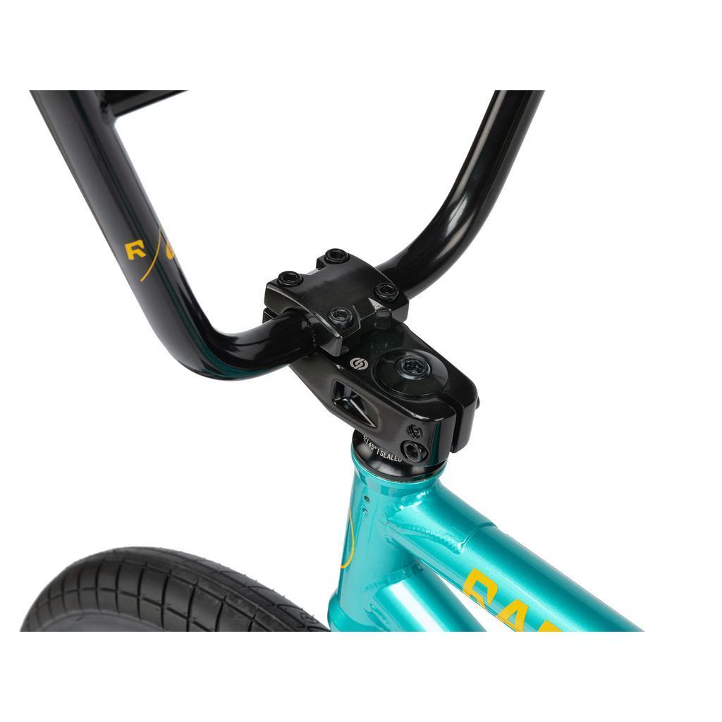 Close-up of the Radio Darko 20 Inch Bike's black handlebars, stem, and front tire, highlighting its metallic turquoise chromoly frame and Salt Burn Tyres.