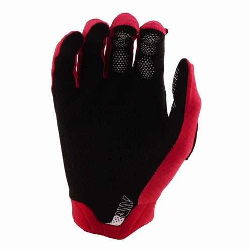 The TLD Air Glove / Mono Scarlet, in black and red with a textured palm, is shown palm up and fingers slightly curved—perfect mountain bike gloves for grip and control.