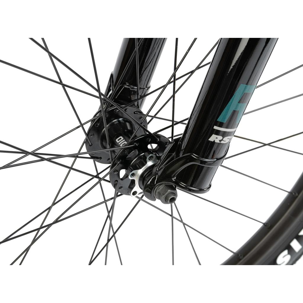 Close-up of the Radio Griffin 26 Inch Bike front wheel with black spokes, hub, axle, fork featuring branding, part of the tire visible, and fitted with Maxxis DTH tyres.