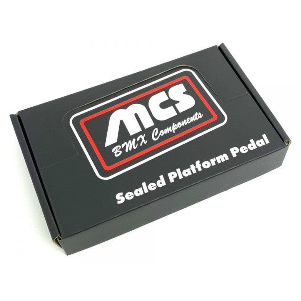 A black box labeled "MCS Sealed Pedals" featuring a red, white, and black logo on the lid, perfect for storing your BMX sealed pedals or thermoplastic nylon pedal set.