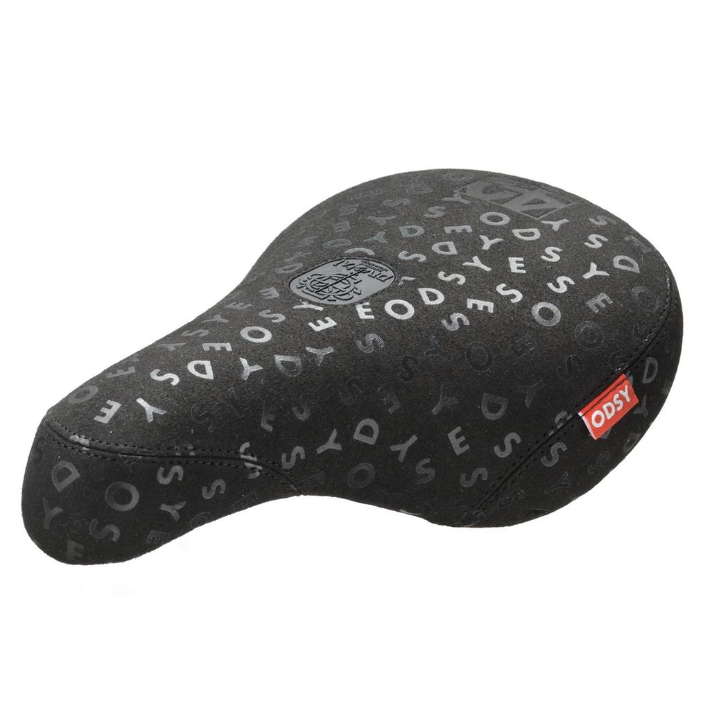 The Odyssey 40th Anniversary Pivotal Seat is a black BMX seat featuring a patterned "ODSY" print and a red ODSY logo tag on the side, released as part of Odyssey's limited edition 40th anniversary collection.