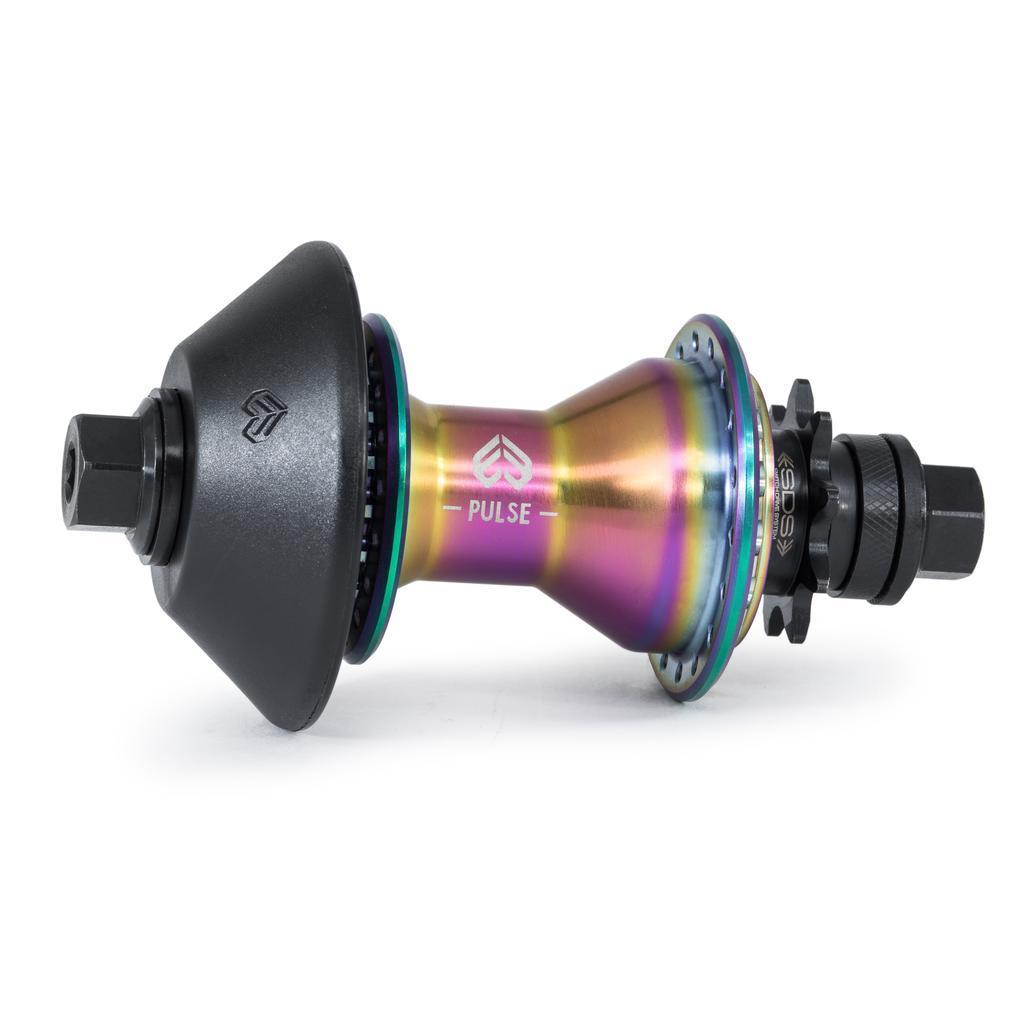 The Eclat Pulse Rear Cassette Hub, shown with a rainbow finish, black guards, and axle bolts against a white background, features the "PULSE" label.