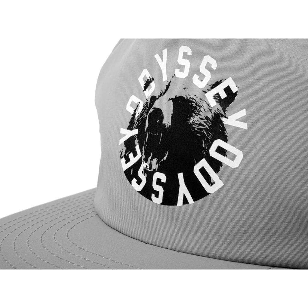 The Odyssey Bear Central 5 Panel Hat is a gray cap with a bear graphic and "ODYSSEY" in white, circular text—perfect for upgrading your style.