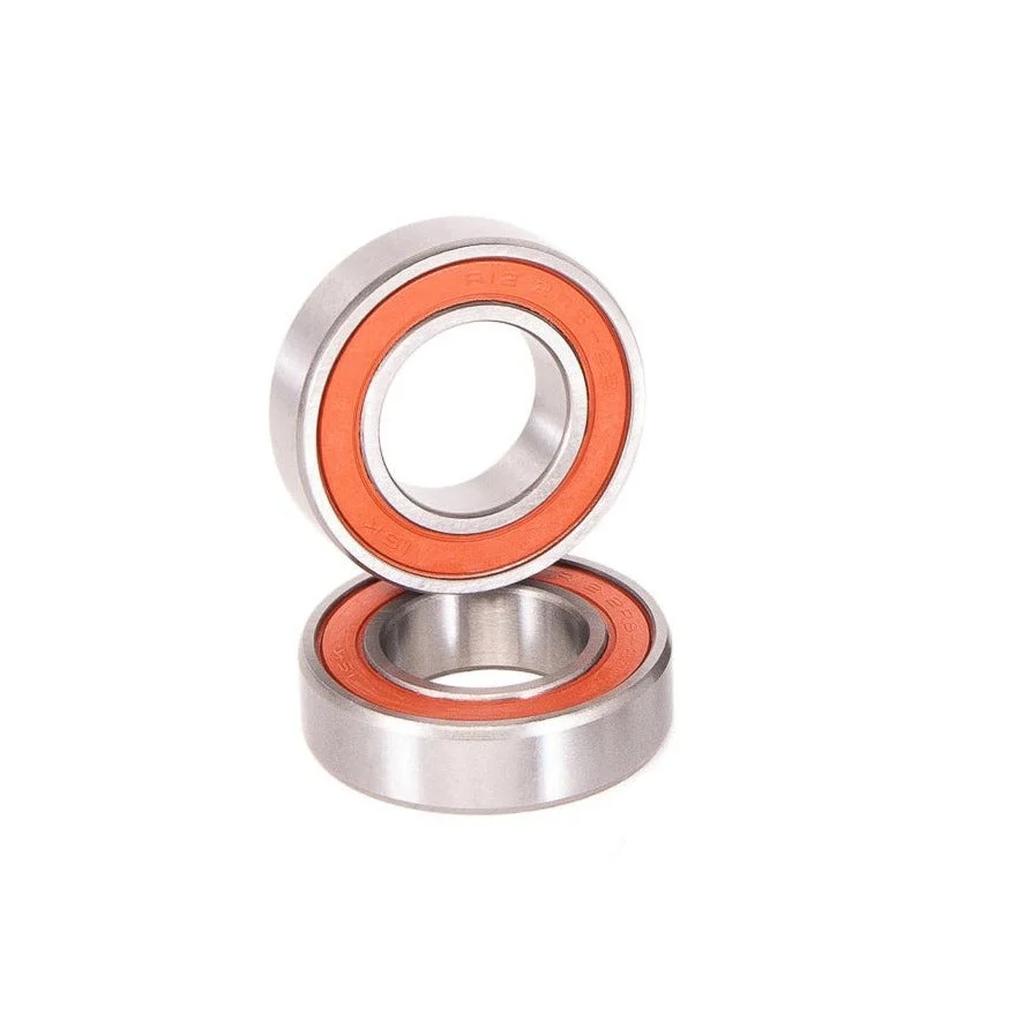 Two Salt Rookie Mid Bottom Bracket Bearings Only with orange seals—one upright, one flat—are displayed against a white background, showcasing their quality sealed bearing construction.